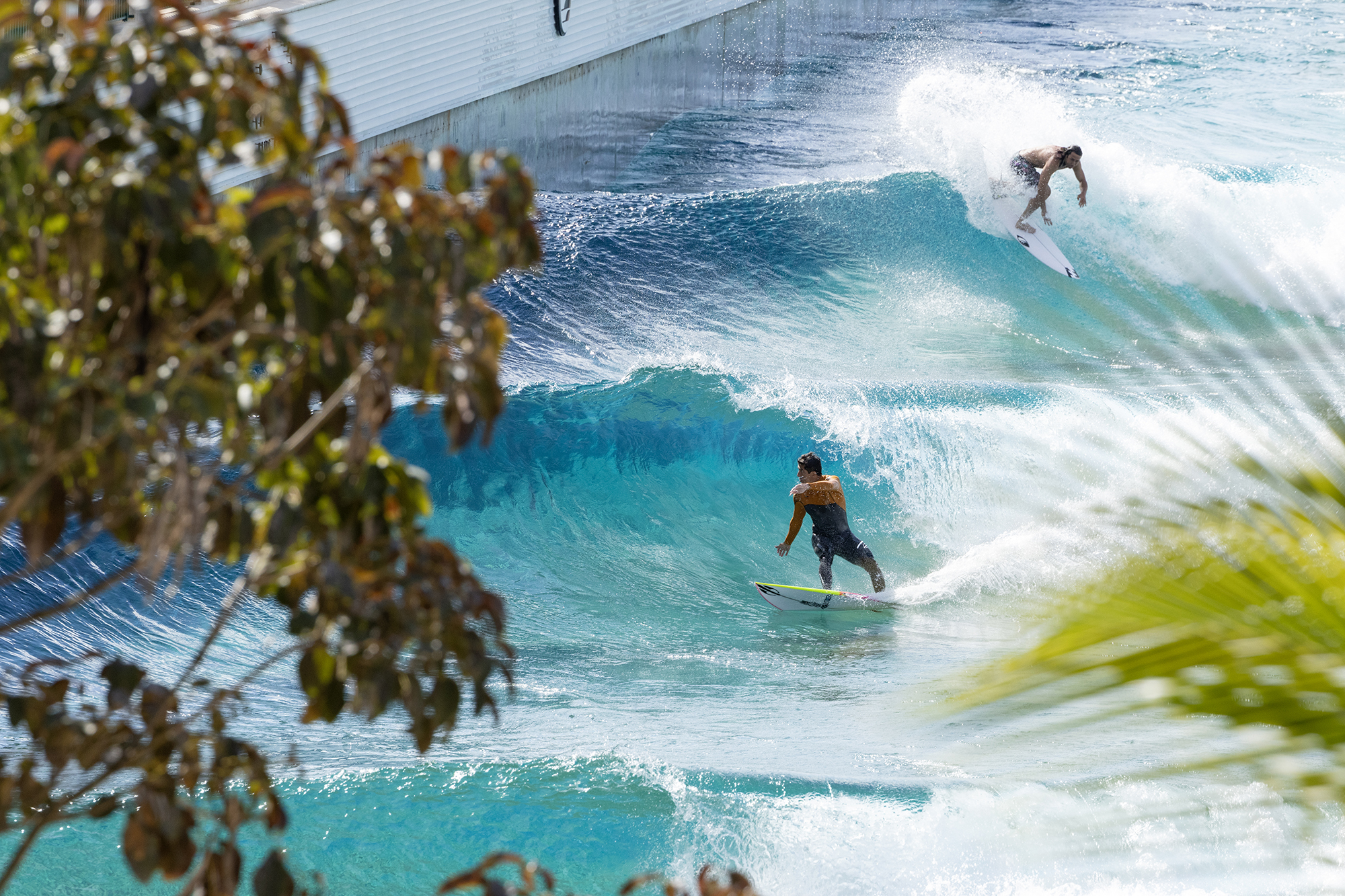 Miguel Pupo and Rob Kelly surfing a Lowers set at PerfectSwell Boa Vista Village