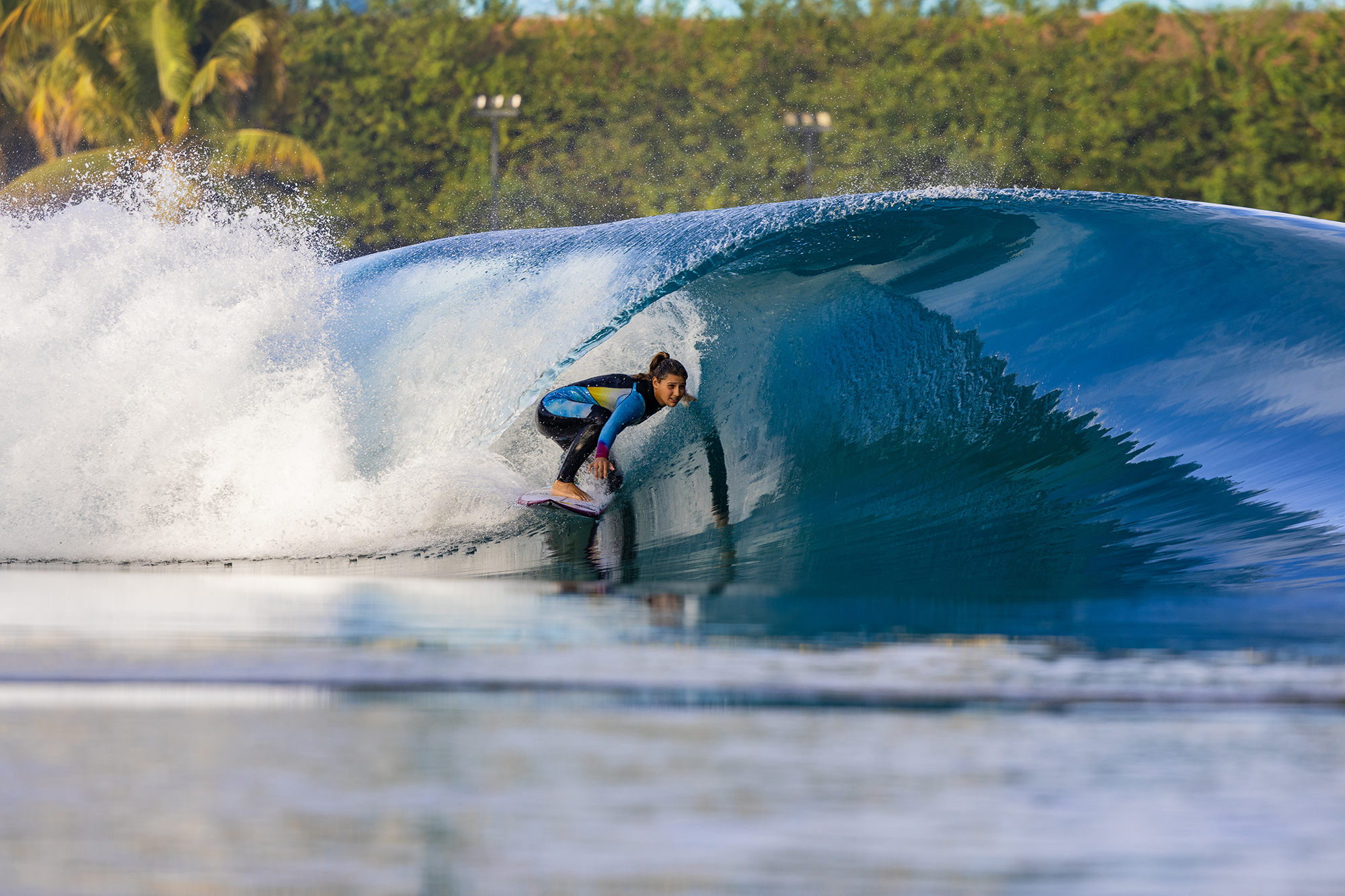 Surfer girl gets a glassy perfectswell barrel at boa vista village